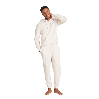 MODEL WEARING BAREFOOT DREAMS MALIBU COLLECTION MENS BRUSHED FLEECE JOGGER IN BISQUE