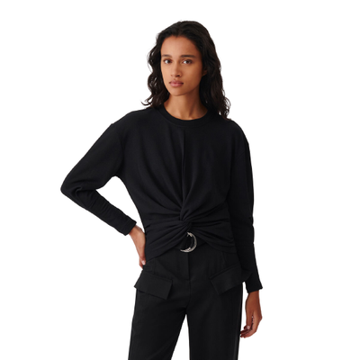 MODEL WEARING IRO COLINE ROUND NECK PLEATED TOP IN BLACK