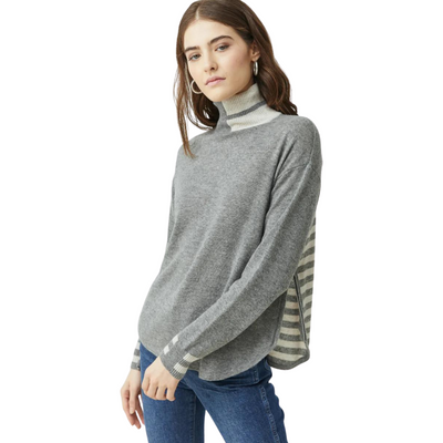 Model standing wearing Shirttail Sweater with side zip in color black/stone